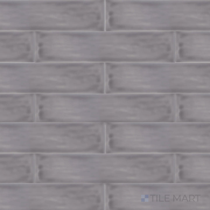 An overhead view of the Flow Lavender 3x12 inch bright ceramic tile captures its soft purple hue and glossy surface, offering a delicate yet sophisticated look.