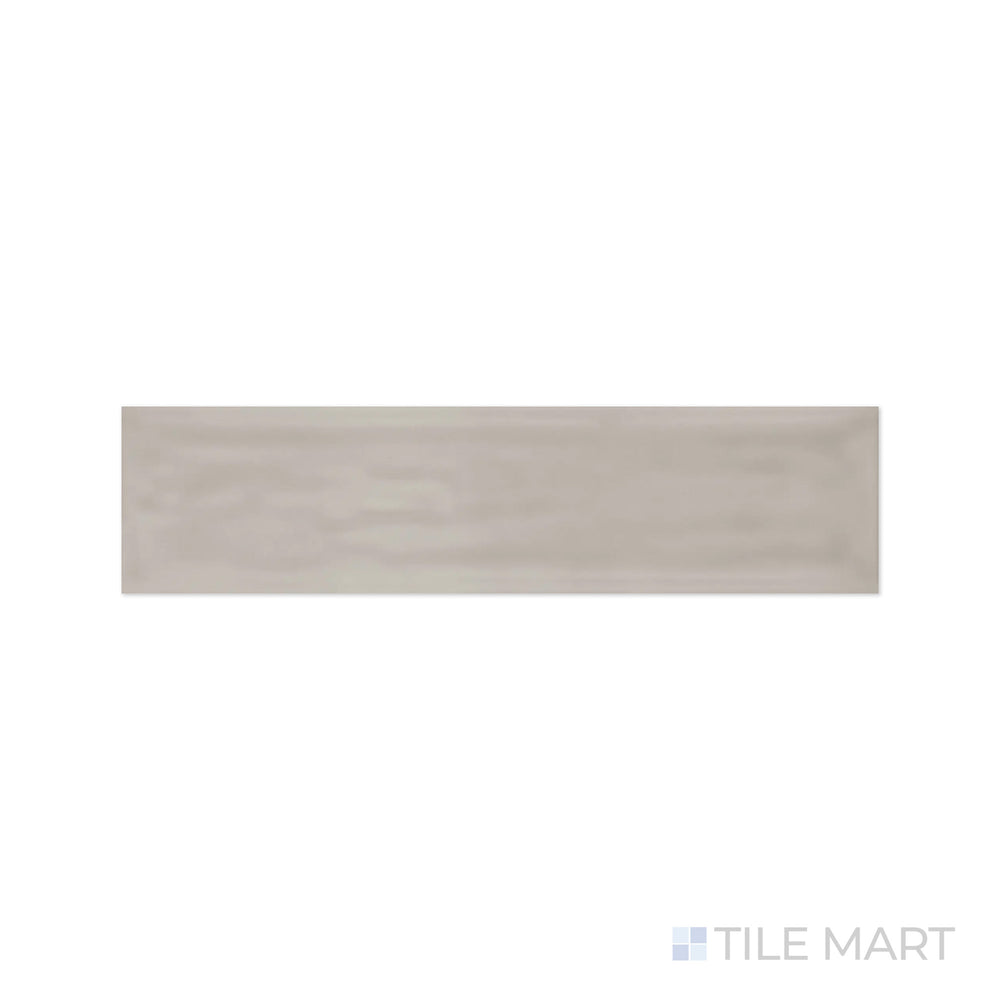 A detailed close-up of Flow Tender Gray 3X12 Bright Ceramic highlights its warm neutral gray hue with a polished finish, bringing balance and harmony to interiors.