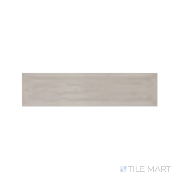 A detailed close-up of Flow Tender Gray 3X12 Bright Ceramic highlights its warm neutral gray hue with a polished finish, bringing balance and harmony to interiors.