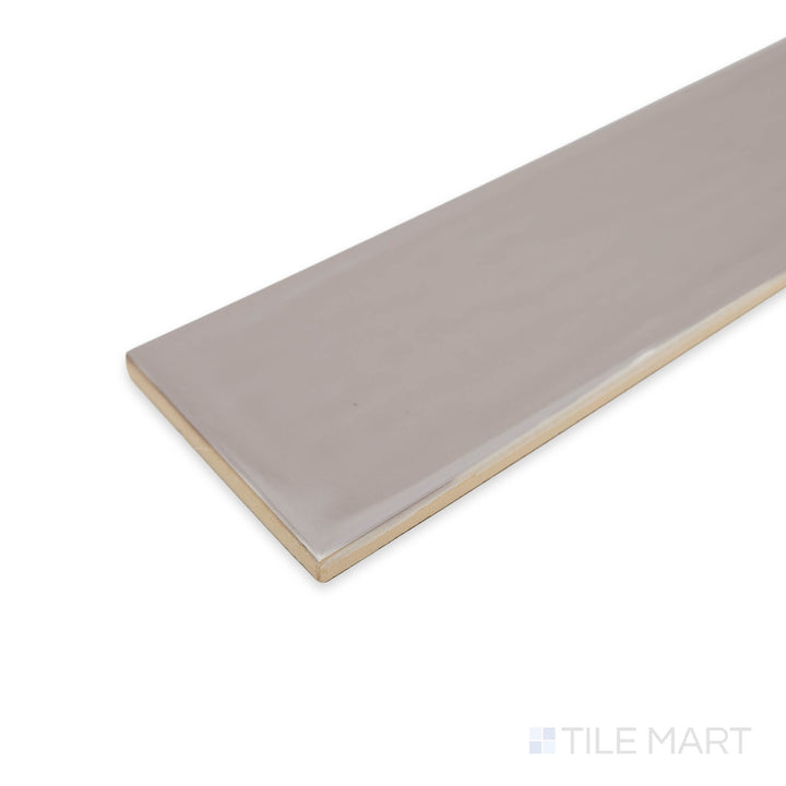 Side view of Flow Tender Gray 3X12 bright ceramic tile at the corner, featuring its warm gray tone, glossy finish, and precise transition at the junction.
