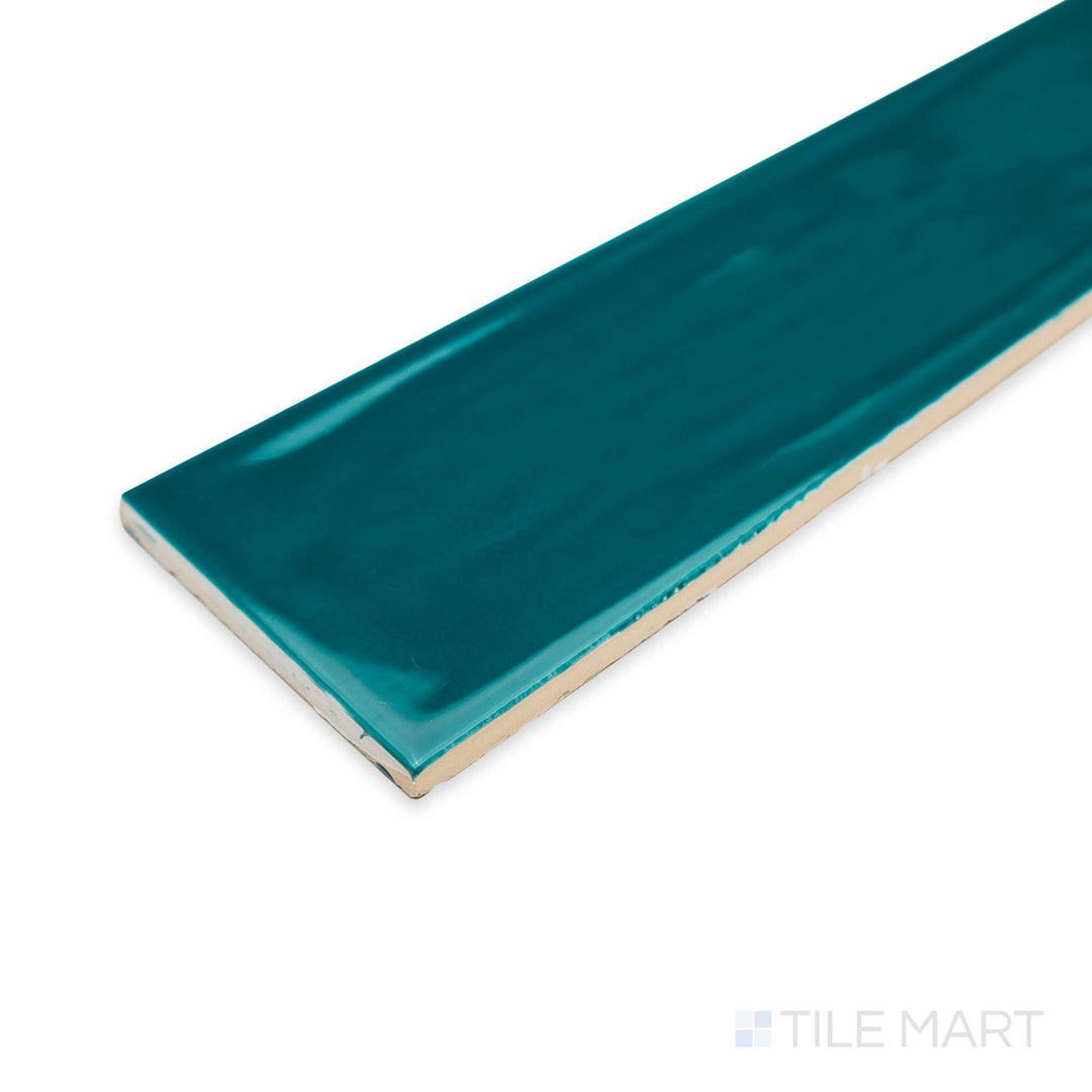 Angled perspective of Flow Peacock Green 3X12 bright ceramic tile, highlighting its vibrant teal hue, high-gloss surface, and crisp edge detailing.