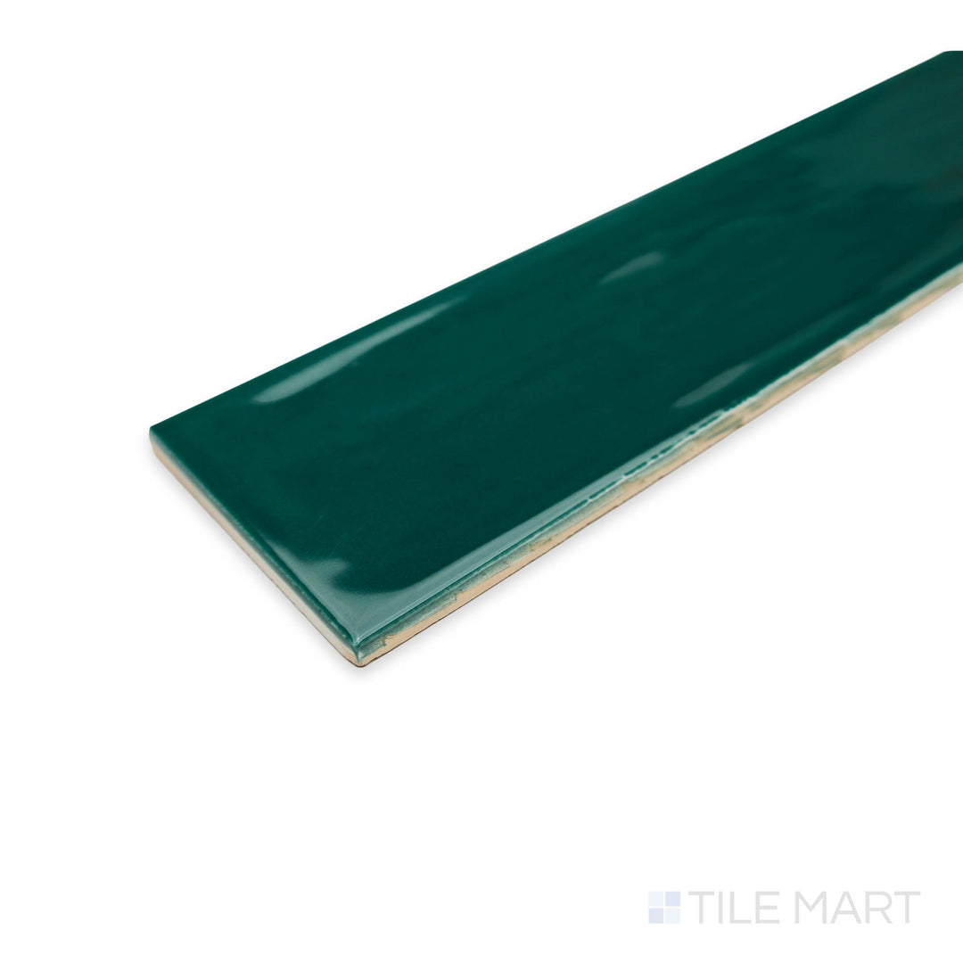 Side view of Flow Living Green 3X12 bright ceramic tile at the corner, featuring its deep emerald shade, polished finish, and structured edge definition.