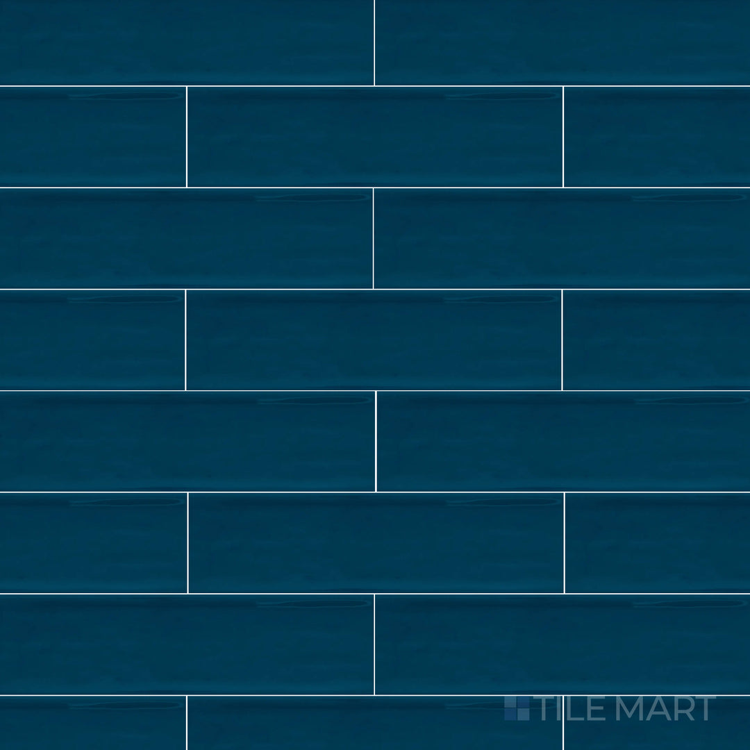 A top-down perspective of the Flow Cosmic Sapphire 3x12 inch bright ceramic tile showcases its deep sapphire blue tone and glossy sheen, enhancing depth and luxury.