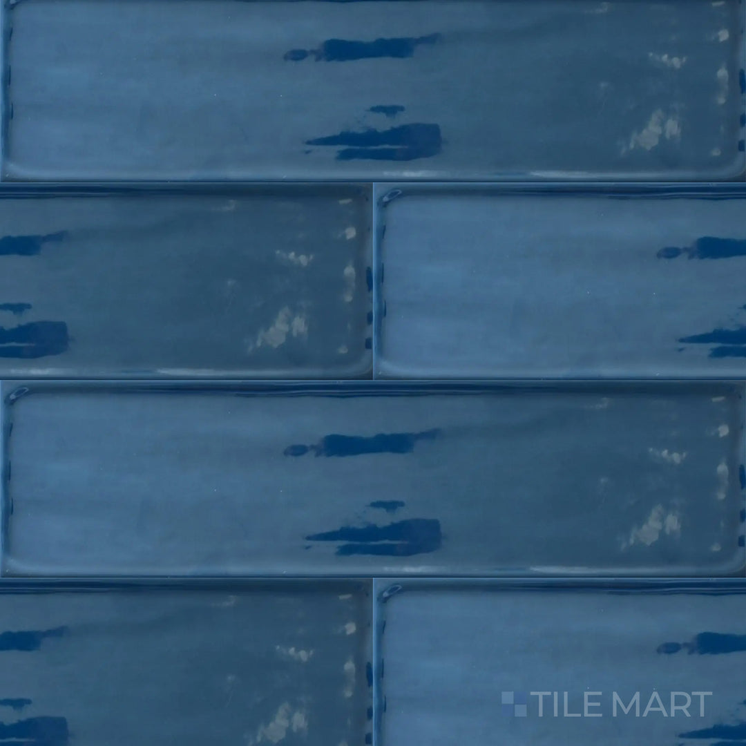 Captured from above, the Flow Cosmic Sapphire 4x16 inch bright ceramic tile presents a luxurious deep blue tone with a glossy sheen, adding drama and elegance to interiors.