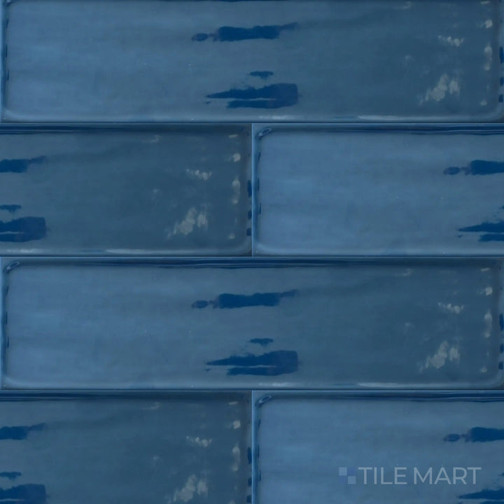 Captured from above, the Flow Cosmic Sapphire 4x16 inch bright ceramic tile presents a luxurious deep blue tone with a glossy sheen, adding drama and elegance to interiors.