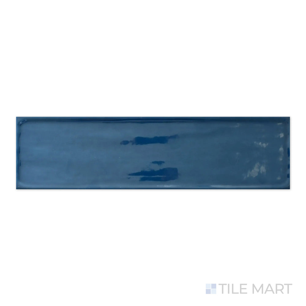 A high-resolution macro view of Flow Cosmic Sapphire 4X16 Bright Ceramic captures its dramatic deep blue hue with a sleek, high-gloss finish, making a bold statement.