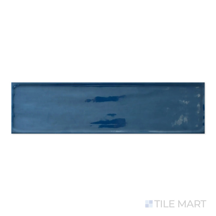 A high-resolution macro view of Flow Cosmic Sapphire 4X16 Bright Ceramic captures its dramatic deep blue hue with a sleek, high-gloss finish, making a bold statement.