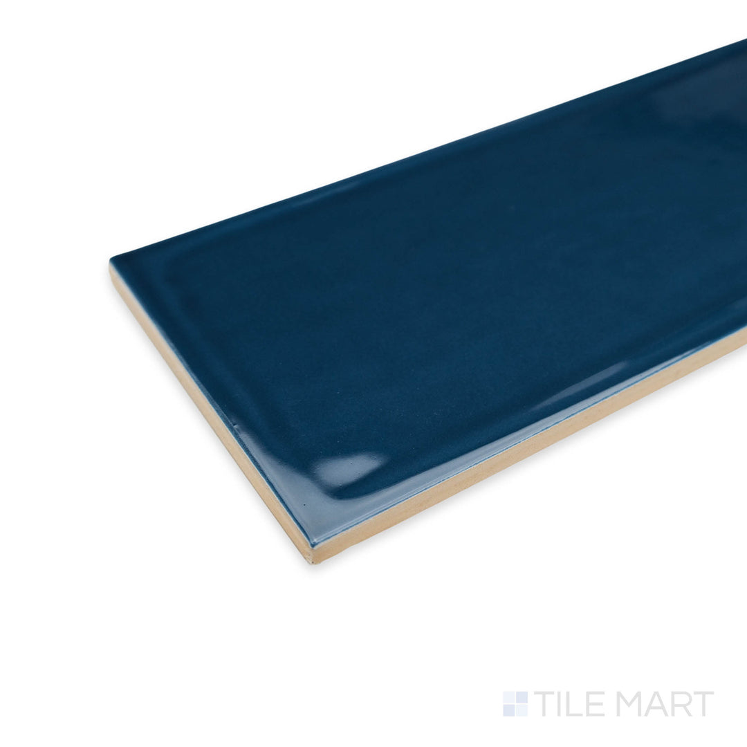 Close-up of Flow Cosmic Sapphire 4X16 bright ceramic tile at the corner, highlighting its jewel-toned blue, reflective surface, and sleek tile alignment.