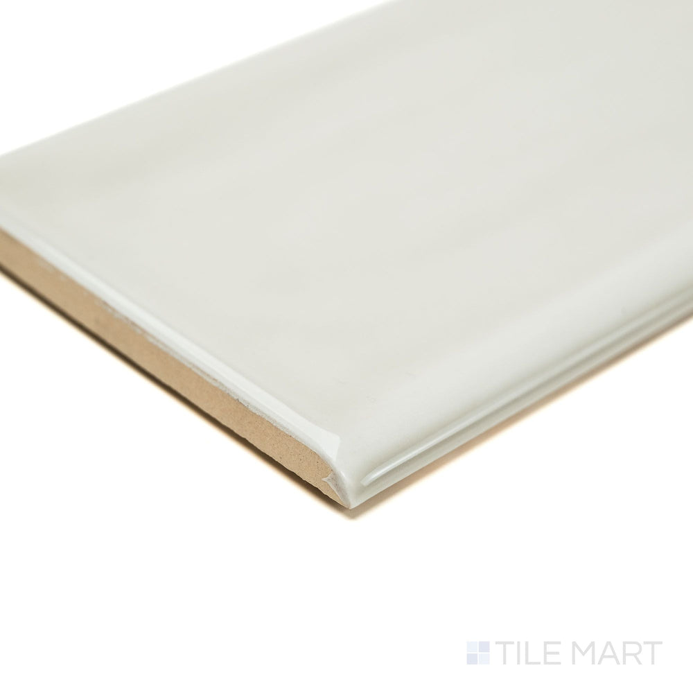 Corner view of Flow Tender Gray 3x12 Bright ceramic bullnose tile, focusing on its soft gray gloss, clean edge, and rounded trim—designed for smooth wall transitions.