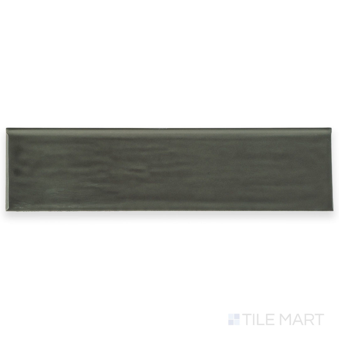 Seen from above, this Flow Dark Gray 3x12 Bright ceramic bullnose tile features a deep gray color with a polished finish and smooth bullnose edge.