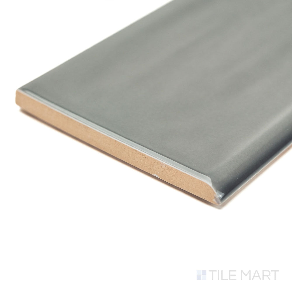 Flow Dark Gray 3x12 Bright ceramic bullnose tile captured at a corner angle, emphasizing its deep gray color, glossy finish, and curved edge for elegant wall finishing.