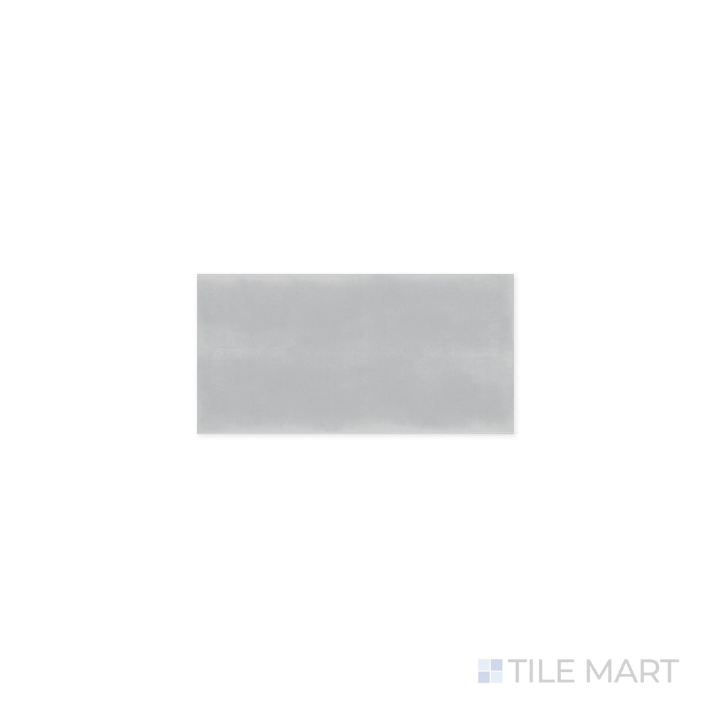 Close-up of Maiolica Tender Gray 3x6 Bright Ceramic Tile, highlighting its soft gray shade with a glossy finish. A sophisticated choice for backsplashes and feature walls, offering a sleek and contemporary feel.