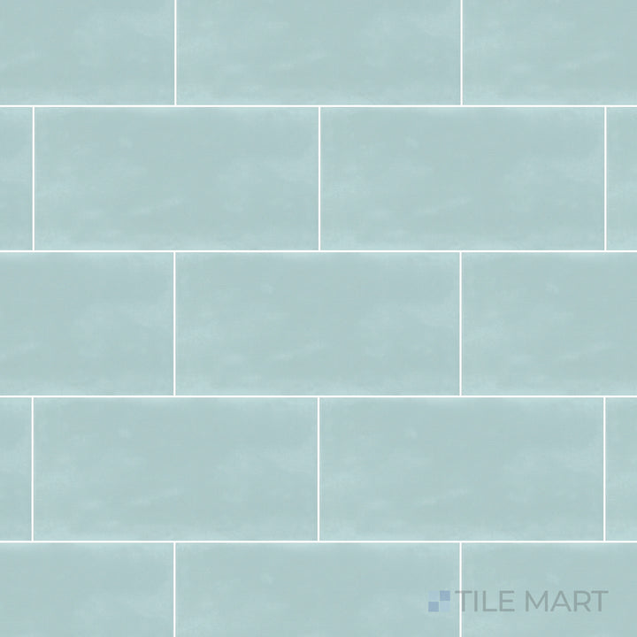 An overhead view of the Maiolica Aqua 3x6 inch bright ceramic tile captures its refreshing aqua hue and glossy sheen, bringing a vibrant and soothing aesthetic.