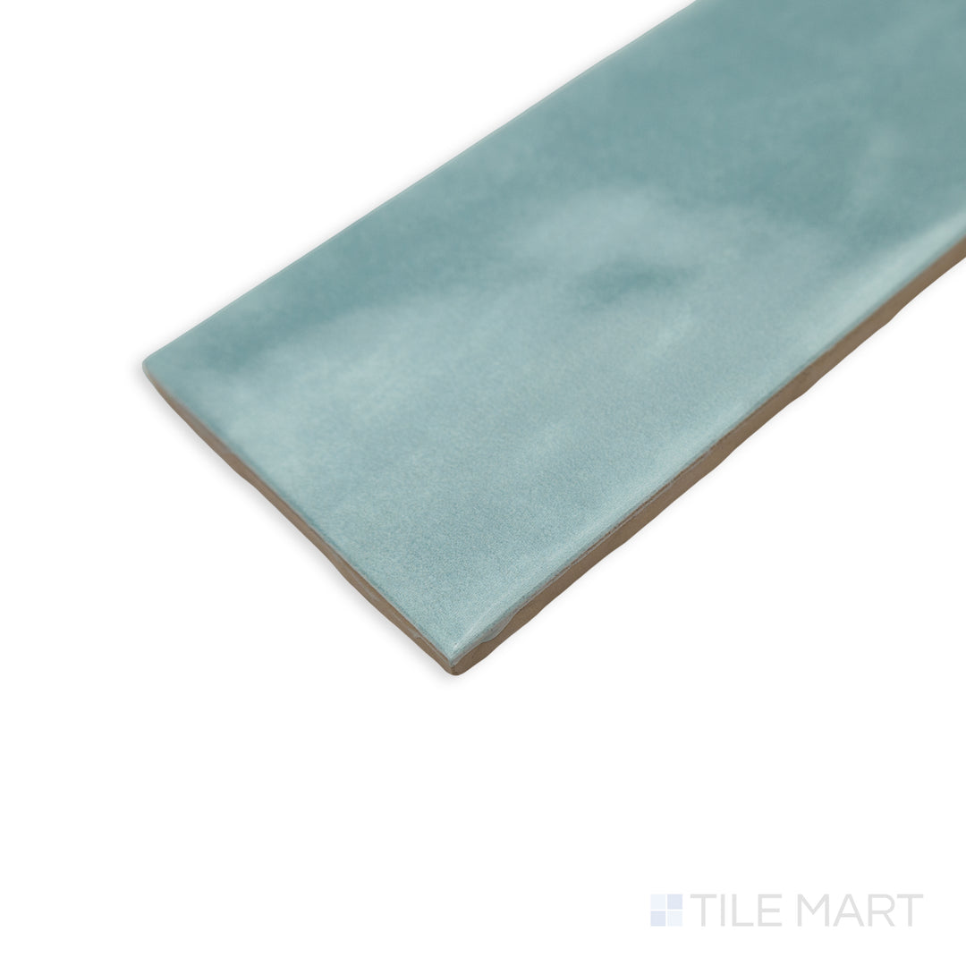 With a fresh and vibrant look, this corner shot of Maiolica Aqua 3x6 bright ceramic tile showcases its cool blue hue and sleek glazed texture.