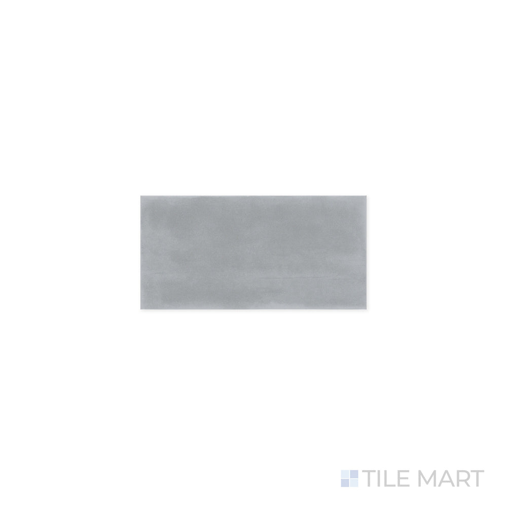 Zoomed-in view of Maiolica Taupe 3x6 Bright Ceramic Tile, capturing its soft neutral tone and high-gloss surface. The refined color and polished sheen create an elegant visual effect.