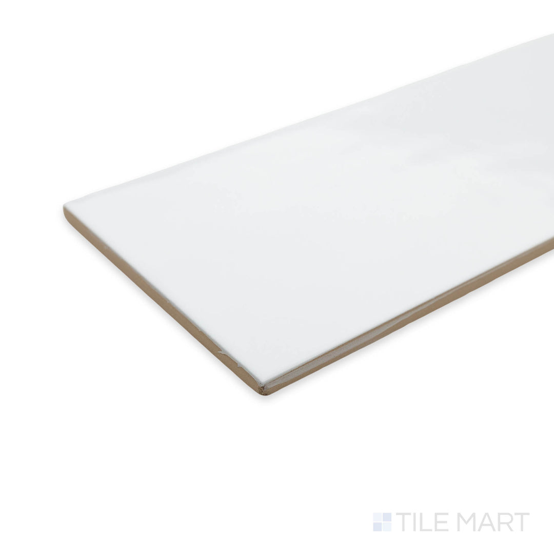 A bright and timeless Maiolica White 4x10 ceramic tile captured in a corner shot, highlighting its glossy surface and clean, elegant aesthetic.