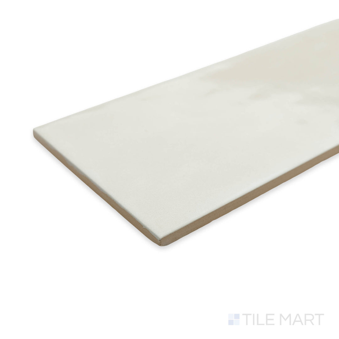 Corner shot of Maiolica Biscuit 4x10 bright ceramic tile, showcasing its warm beige undertones and glossy sheen for a cozy yet sophisticated look.