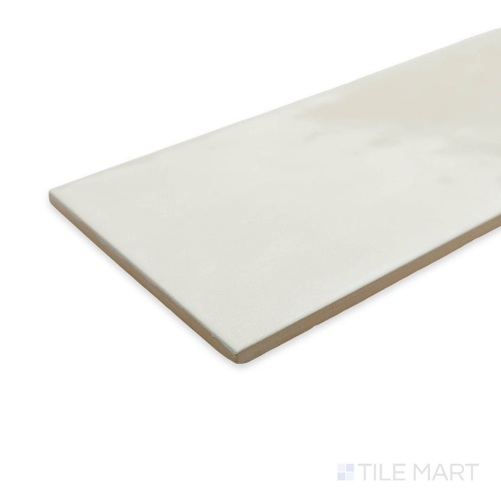 Corner shot of Maiolica Biscuit 4x10 bright ceramic tile, showcasing its warm beige undertones and glossy sheen for a cozy yet sophisticated look.