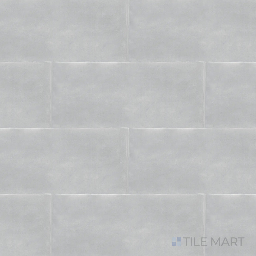 Captured from above, the Maiolica Tender Gray 4x10 inch bright ceramic tile features a muted gray tone with a glossy finish, adding a sleek and versatile appeal.