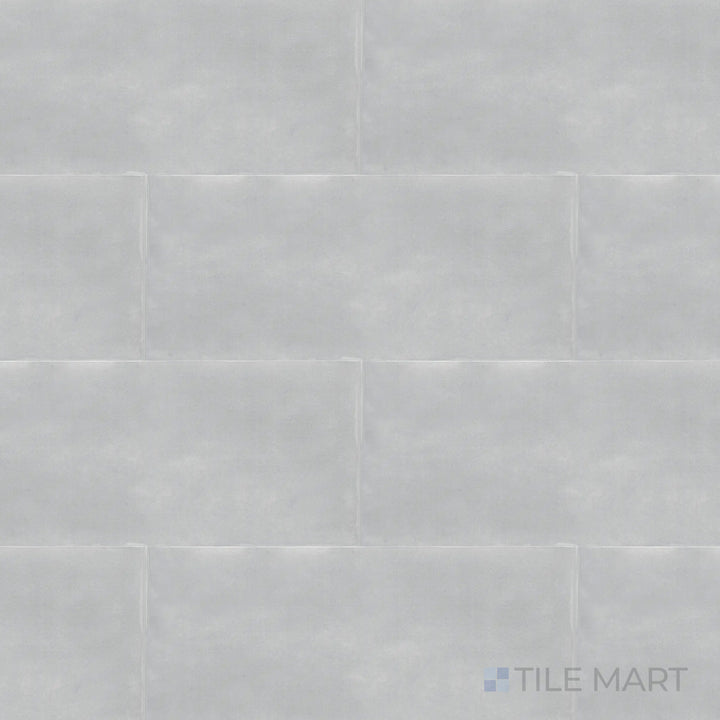 Captured from above, the Maiolica Tender Gray 4x10 inch bright ceramic tile features a muted gray tone with a glossy finish, adding a sleek and versatile appeal.