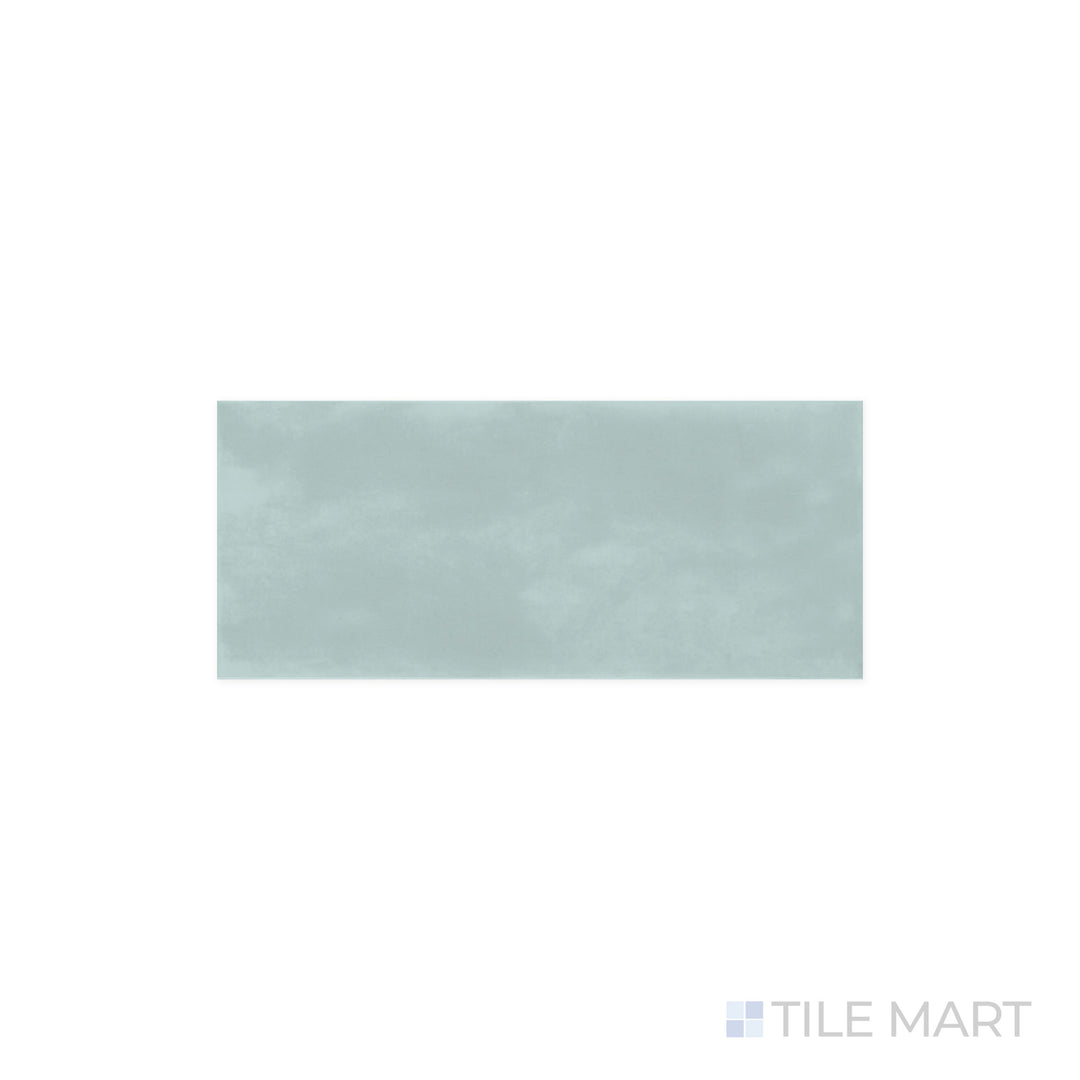 Close-up of Maiolica Aqua 4x10 Bright Ceramic Tile, revealing its rich blue-green tone and luminous finish. The glossy surface enhances color depth and creates a striking visual impact.