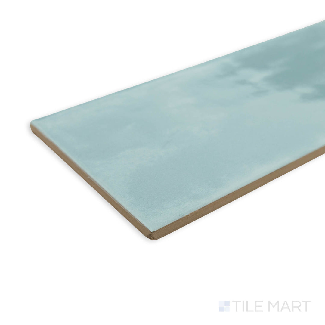 Maiolica Aqua 4x10 bright ceramic tile in a corner perspective, displaying its serene blue hue and polished finish that enhances depth and brightness.