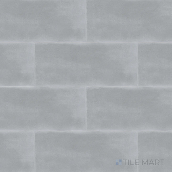 This top-down shot of the Maiolica Taupe 4x10 inch bright ceramic tile highlights its warm taupe shade and polished surface, offering a cozy yet stylish touch.