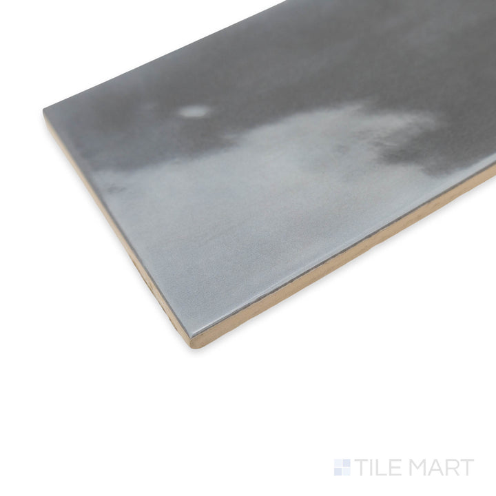 Stylish and earthy, the Maiolica Taupe 4x10 bright ceramic tile is shown in a corner shot, emphasizing its warm brown tones and glossy texture.