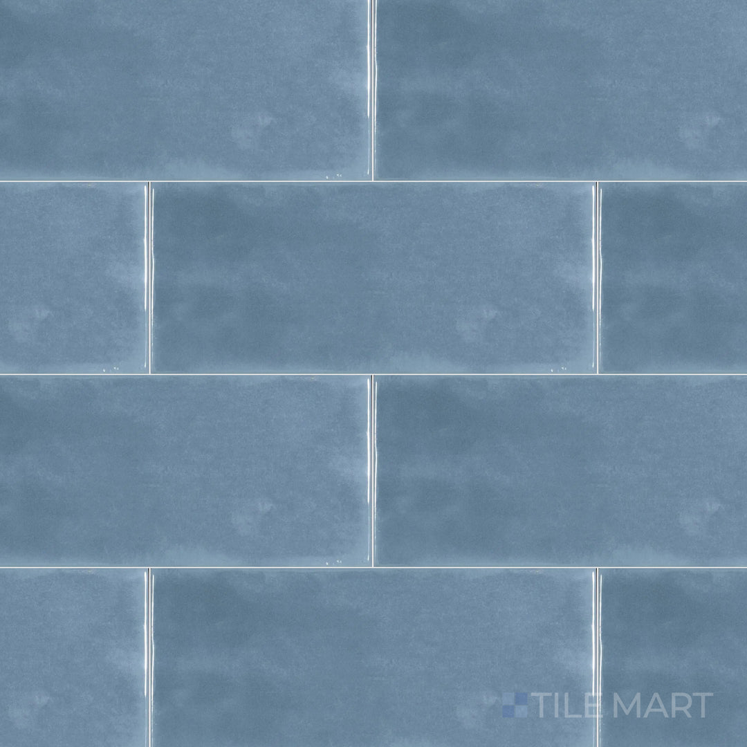An overhead perspective of the Maiolica Blue Steel 4x10 inch bright ceramic tile showcases its deep blue-gray hue and reflective finish, bringing depth and modernity.