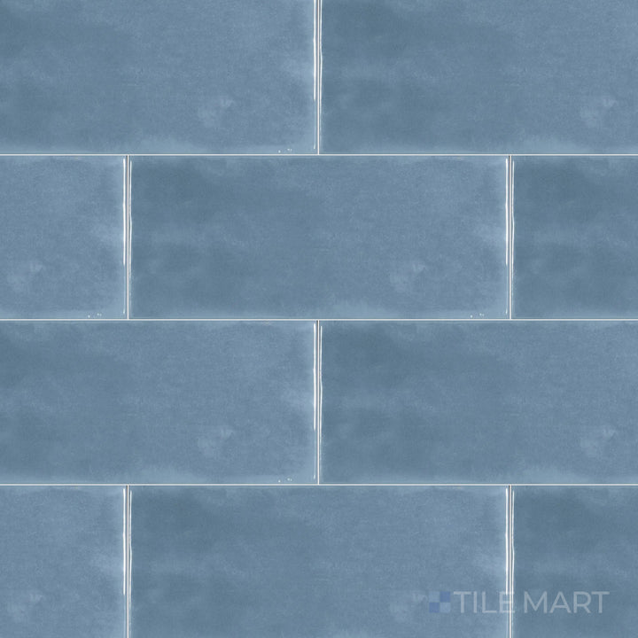 An overhead perspective of the Maiolica Blue Steel 4x10 inch bright ceramic tile showcases its deep blue-gray hue and reflective finish, bringing depth and modernity.