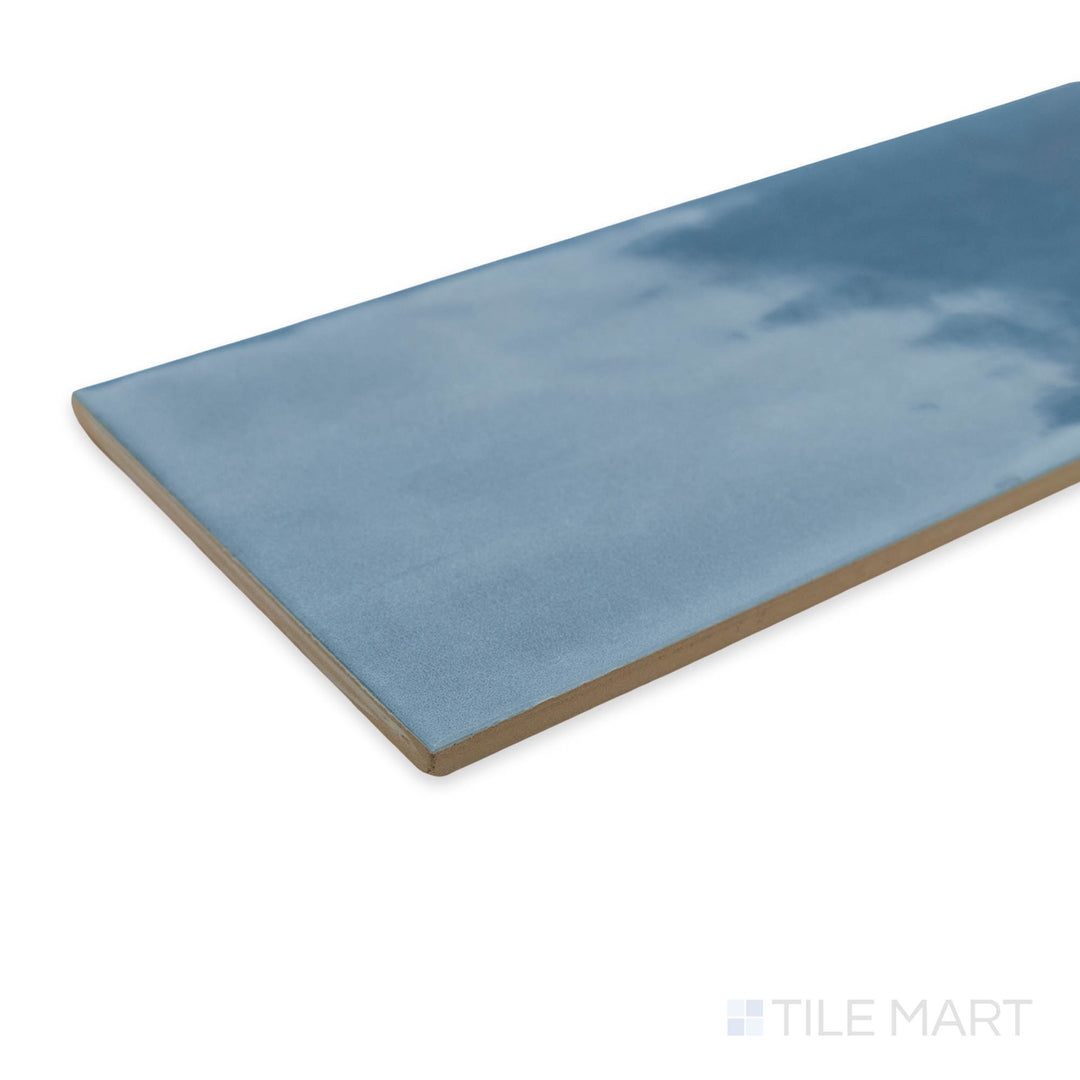 A bold corner view of Maiolica Blue Steel 4x10 bright ceramic tile, highlighting its deep blue shade and high-gloss finish for a dramatic, modern touch.