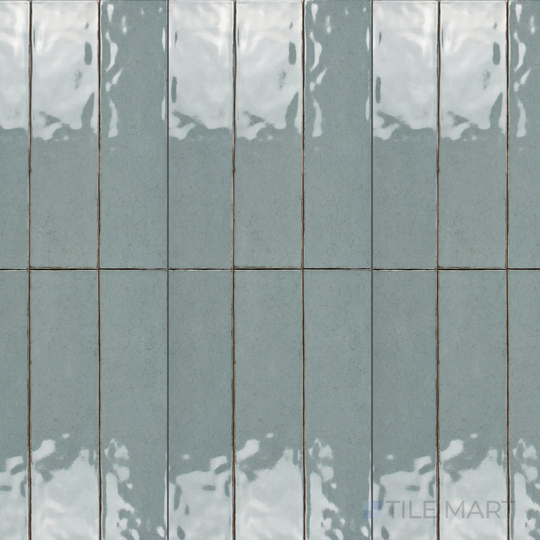 An overhead view of the Maiolica Aqua 3x12 inch bright ceramic tile showcases its vibrant aqua hue and glossy finish, adding a fresh and modern touch to interiors.