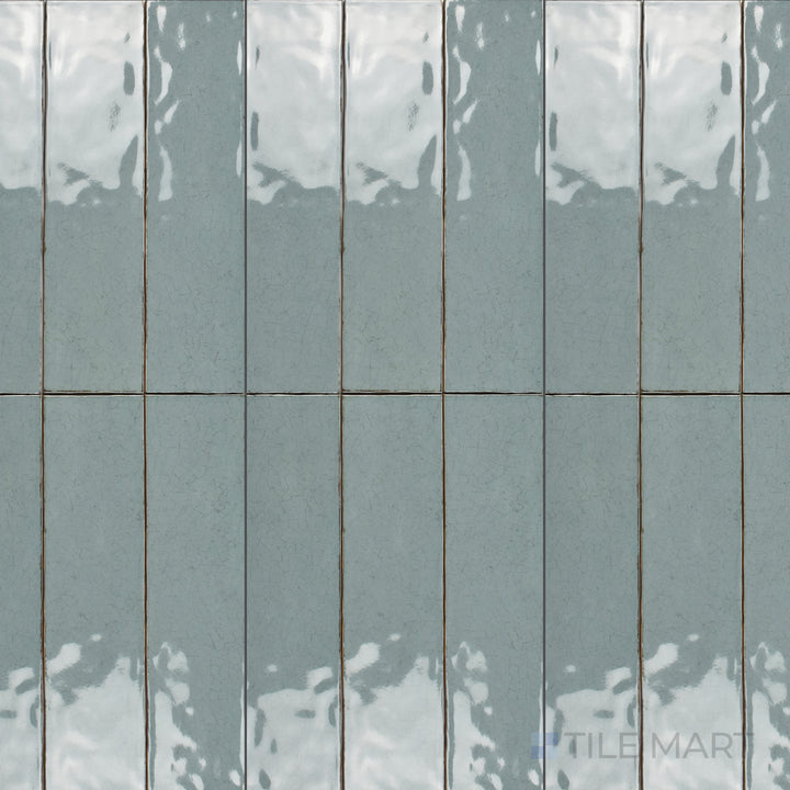 An overhead view of the Maiolica Aqua 3x12 inch bright ceramic tile showcases its vibrant aqua hue and glossy finish, adding a fresh and modern touch to interiors.