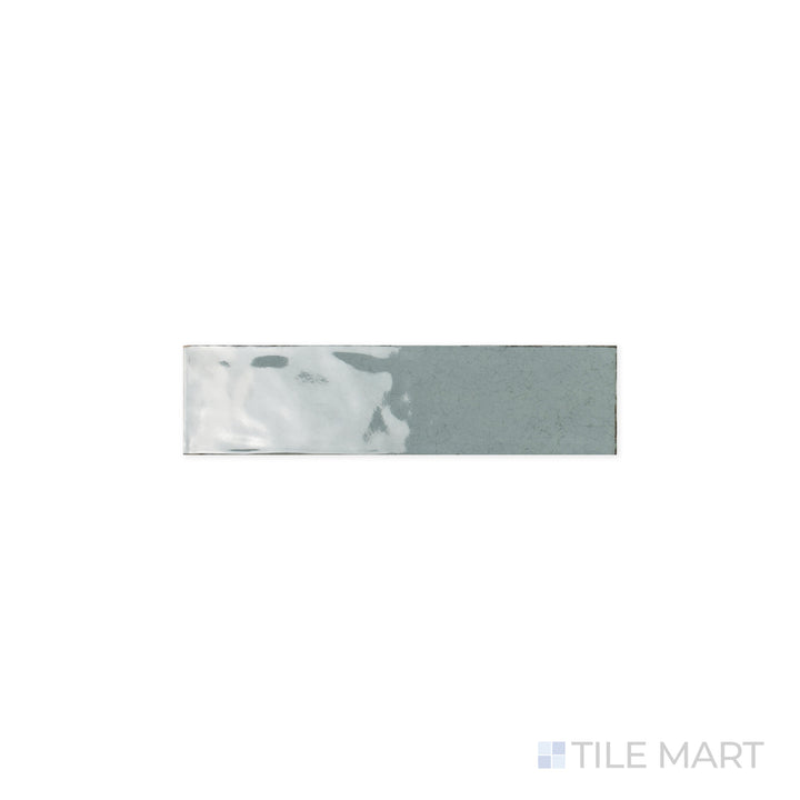 Close-up of Maiolica Aqua 3x12 Bright Ceramic Tile, featuring its fresh aqua hue and radiant finish. The glossy surface amplifies the vibrancy, creating a bold yet refined effect.