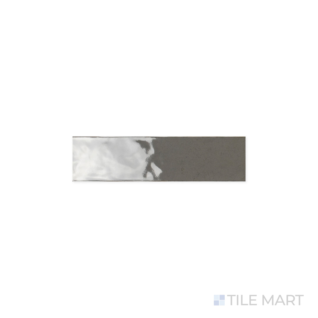 Detailed look at Maiolica Taupe 3x12 Bright Ceramic Tile, where the muted taupe hue is accentuated by a glossy finish. The polished surface enhances depth and color vibrancy.