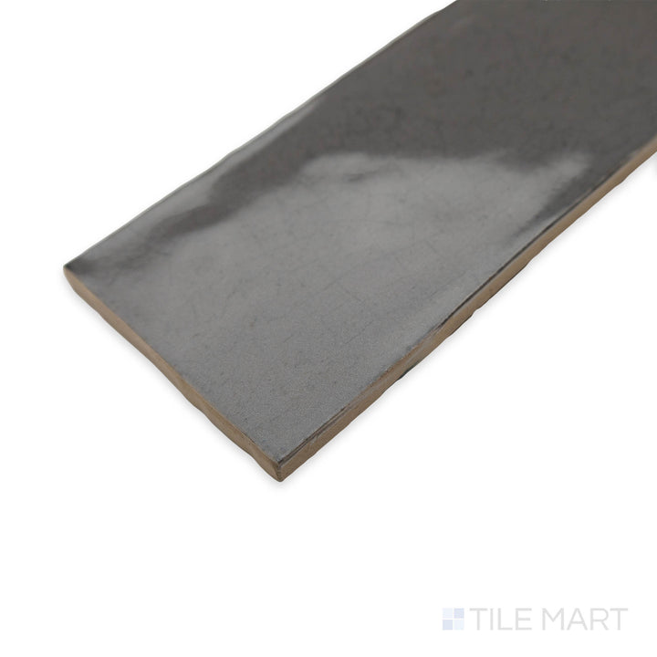 Maiolica Taupe 3x12 bright ceramic tile in a stylish corner shot, featuring its earthy brown tones and glossy texture for a timeless design.