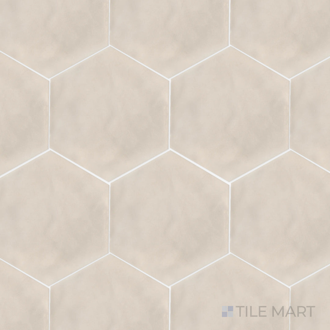A high-angle view of the Maiolica Biscuit 8-inch hexagon bright ceramic tile presents its warm beige tone and polished surface, bringing a soft and welcoming feel to interiors.