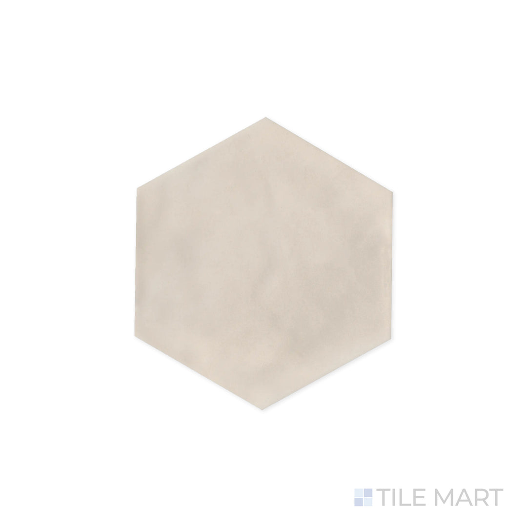 Close-up focus on Maiolica Biscuit 8" Hexagon Bright Ceramic Tile, emphasizing its warm beige hue and glossy sheen. The geometric shape enhances its contemporary appeal.