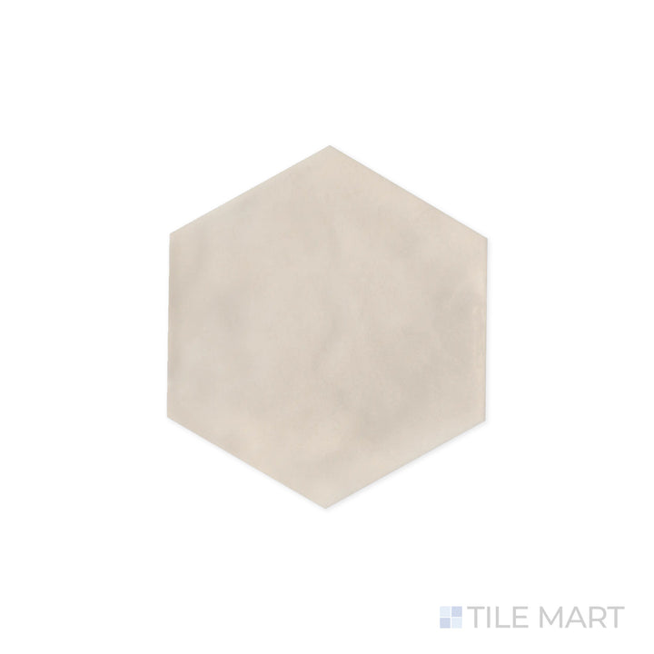 Close-up focus on Maiolica Biscuit 8" Hexagon Bright Ceramic Tile, emphasizing its warm beige hue and glossy sheen. The geometric shape enhances its contemporary appeal.
