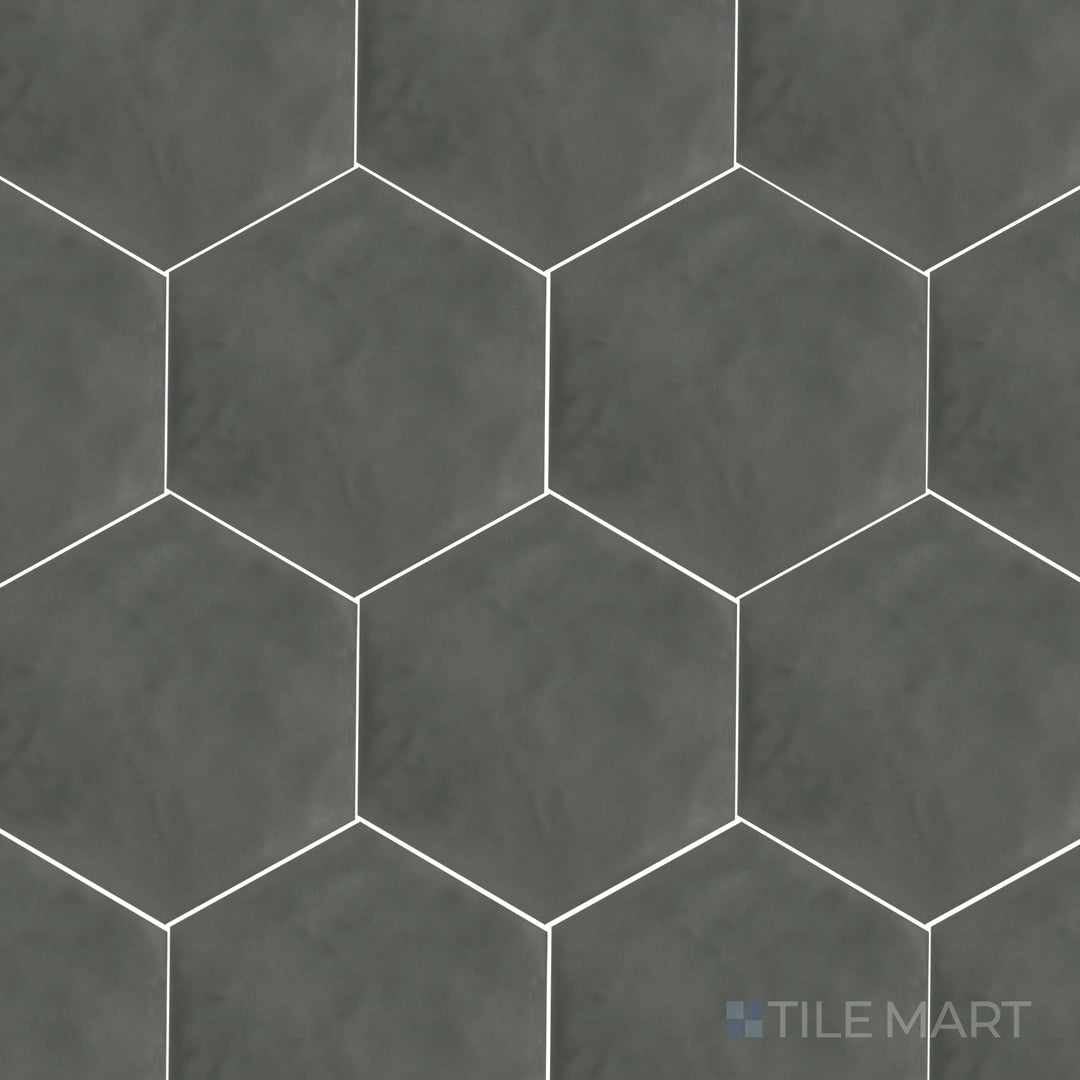 This top-down shot of the Maiolica Taupe 8-inch hexagon bright ceramic tile highlights its rich taupe shade and reflective glaze, perfect for a sophisticated yet cozy look.