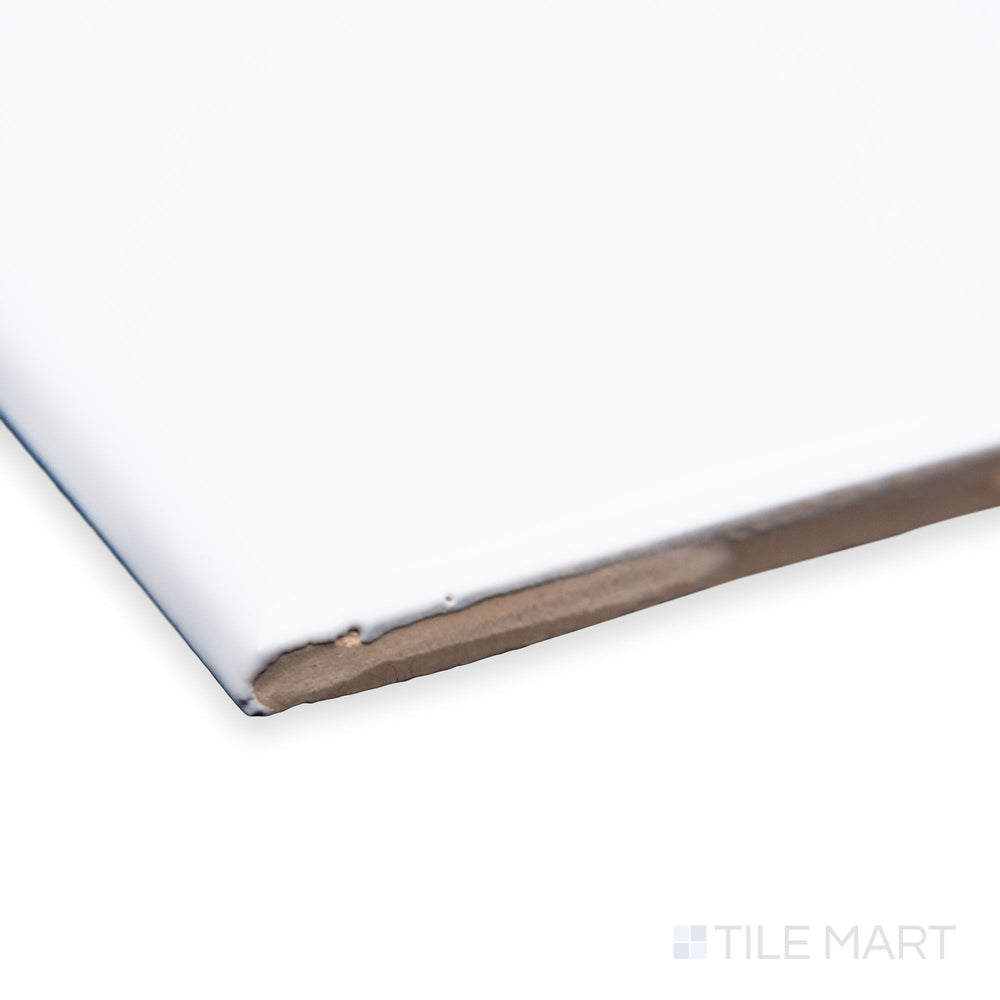 A detailed corner view of Maiolica White 3X6 bright ceramic bullnose, showcasing its clean white shade, soft rounded edge, and glossy ceramic glaze.