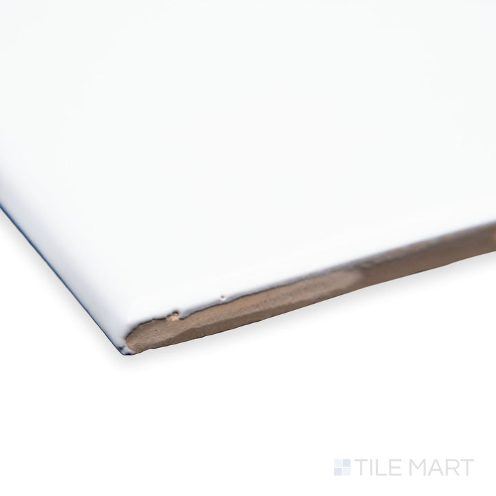 A detailed corner view of Maiolica White 3X6 bright ceramic bullnose, showcasing its clean white shade, soft rounded edge, and glossy ceramic glaze.