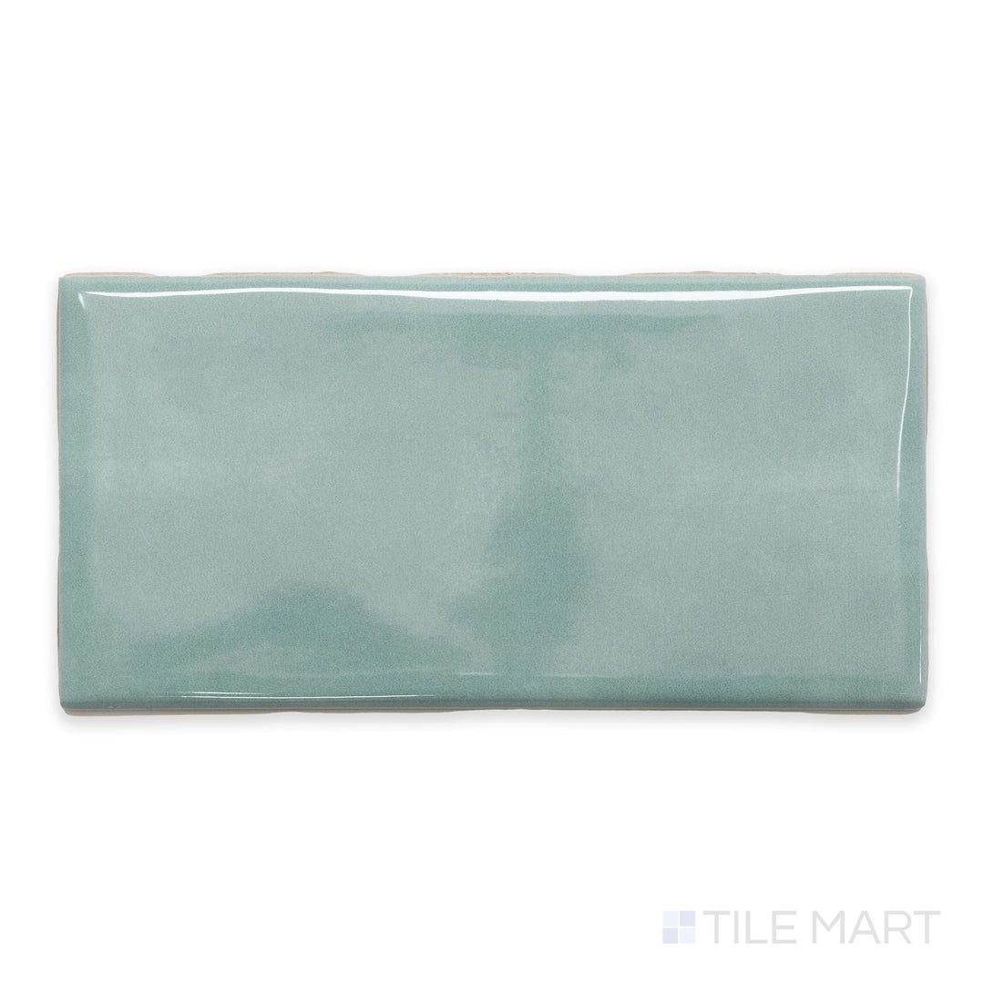 A flat-lay shot of Maiolica Aqua 3x6 bright ceramic