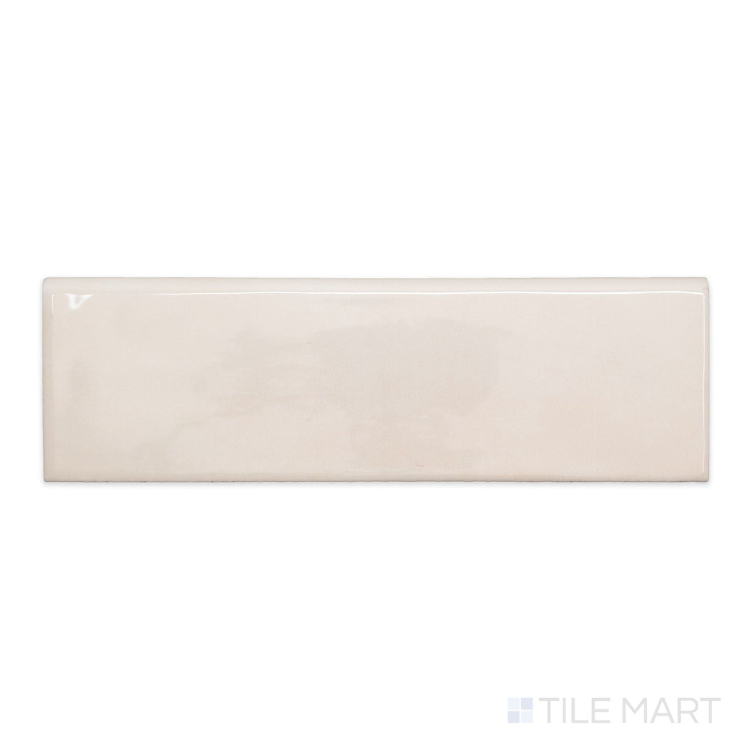 An overview of Maiolica Biscuit 3x10 bright ceramic bullnose, featuring a soft beige hue and polished ceramic surface.