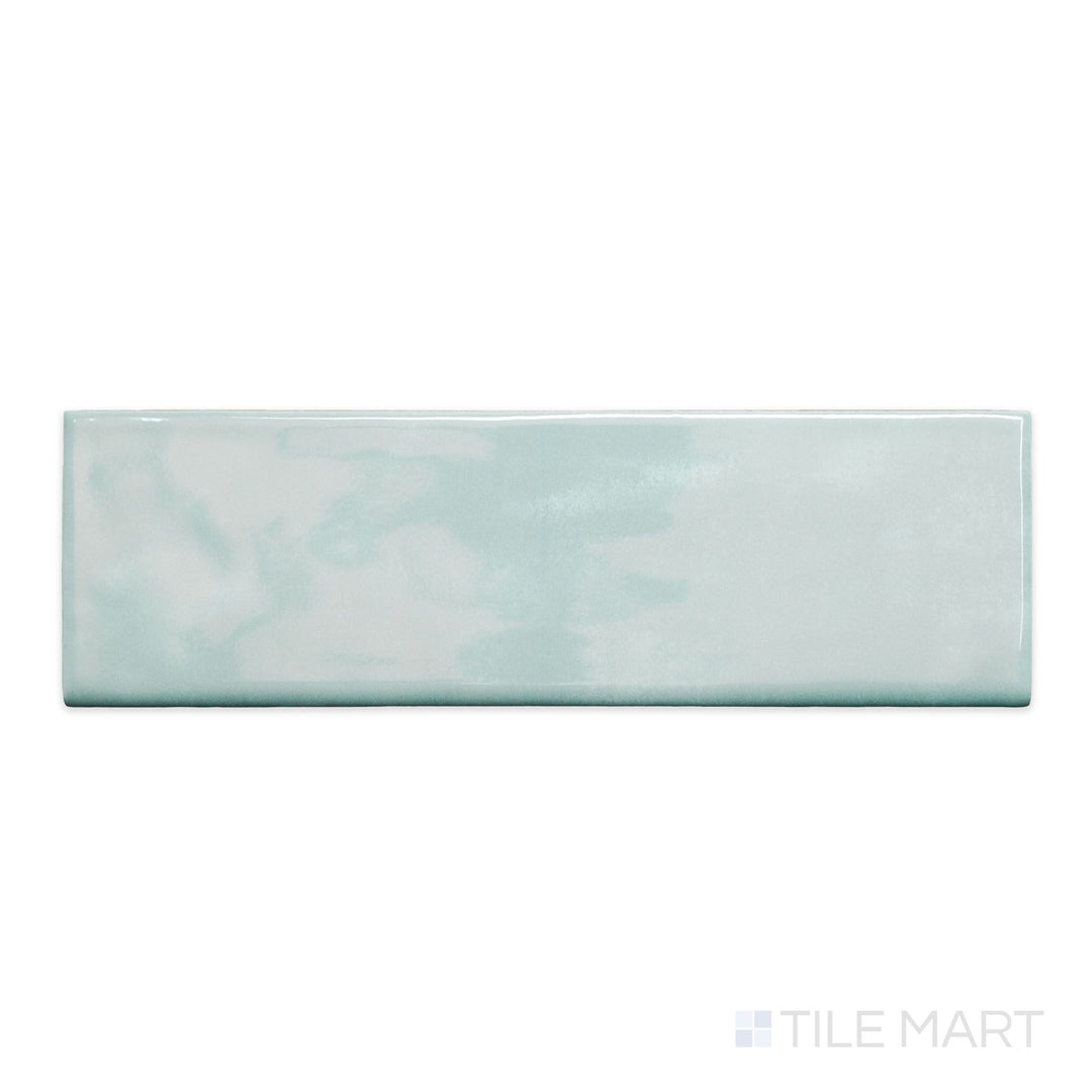 A top-down view of Maiolica Aqua 3x10 bright ceramic bullnose, showcasing its vibrant aqua tone and glossy finish.