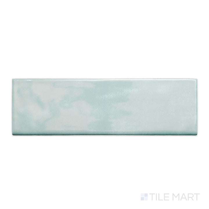 A top-down view of Maiolica Aqua 3x10 bright ceramic bullnose, showcasing its vibrant aqua tone and glossy finish.