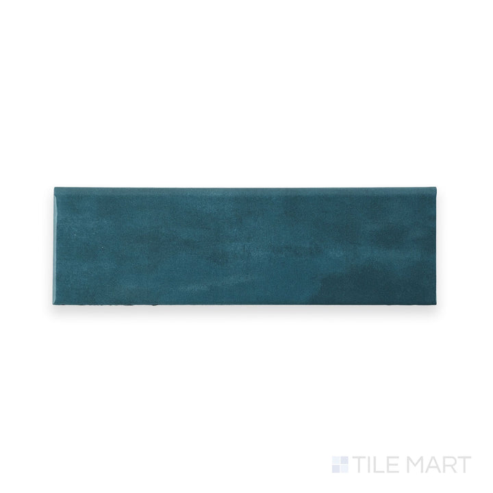 Top-down image of Maiolica Blue Steel 3x10 Bright ceramic bullnose tile, showcasing its glossy navy tone and refined edge profile.