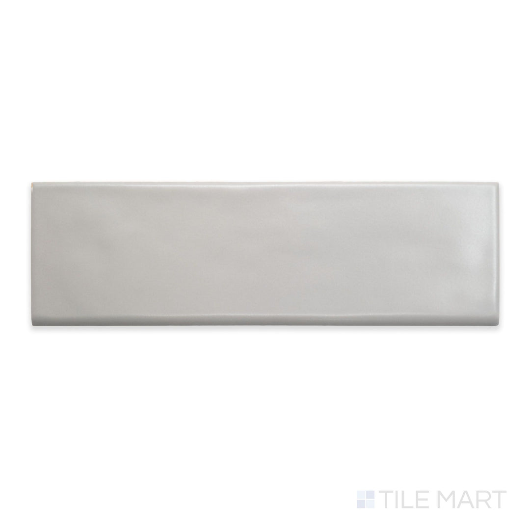 A flat-lay shot of Maiolica Tender Gray 3x10 matte ceramic bullnose, displaying its muted gray color and soft matte surface.