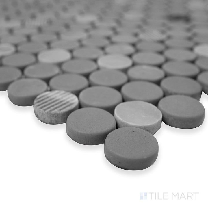 Rockart Gray Penny Round matte and polished granite mosaic in a detailed corner shot, showcasing a mix of recycled glass and natural stone textures.