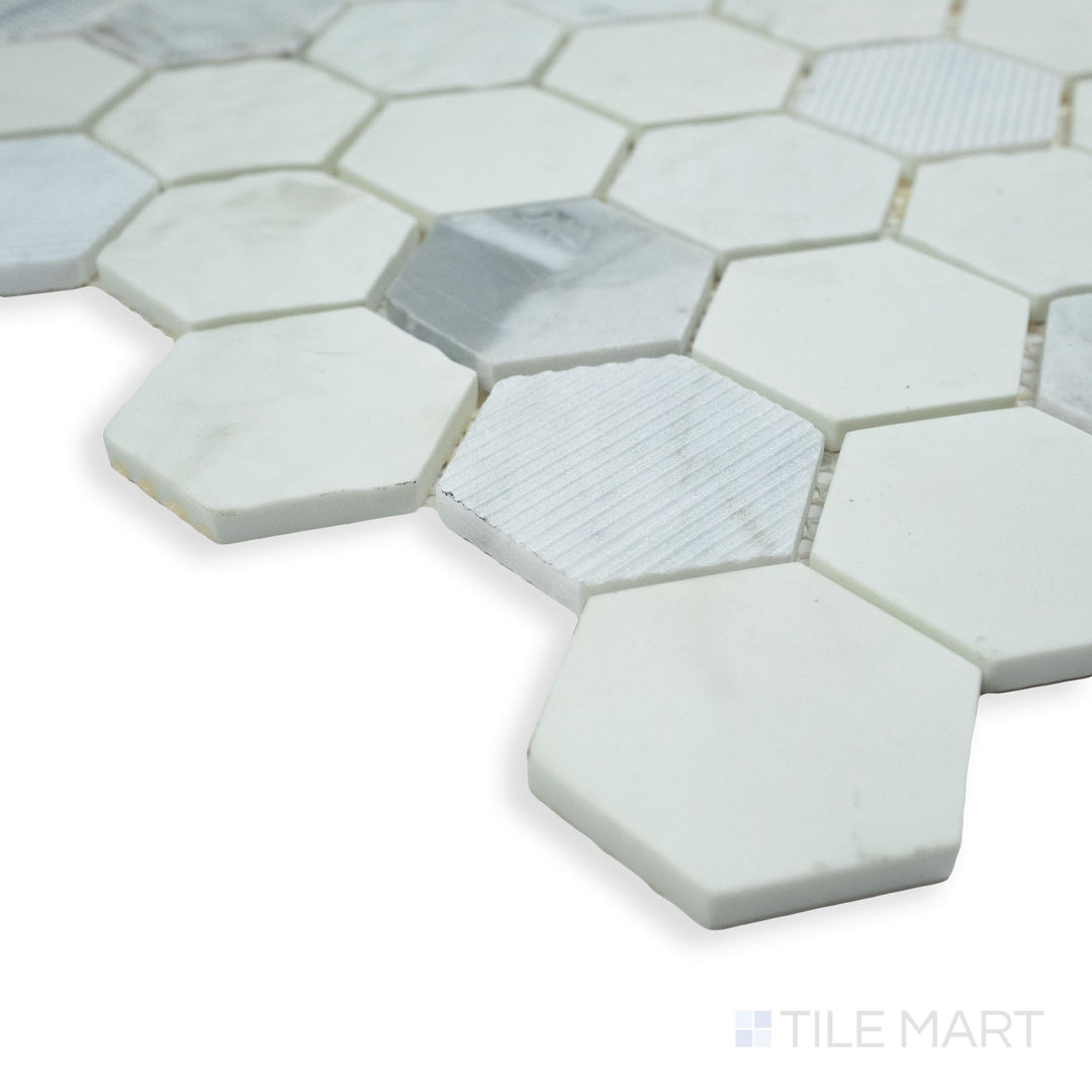A stylish and modern corner perspective of Rockart Carrara Hexagon matte and polished marble mosaic, featuring a blend of recycled glass and luxurious stone.